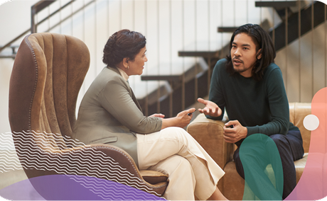 Two people sitting down talking